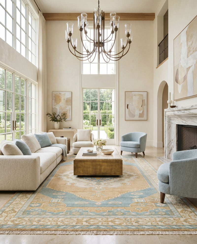 Anadolu AAU-2308 Hand Knotted Rug as the centerpiece of a bright luxury living room — a hand knotted traditional area rug in camel, tan, pale blue and blue tones