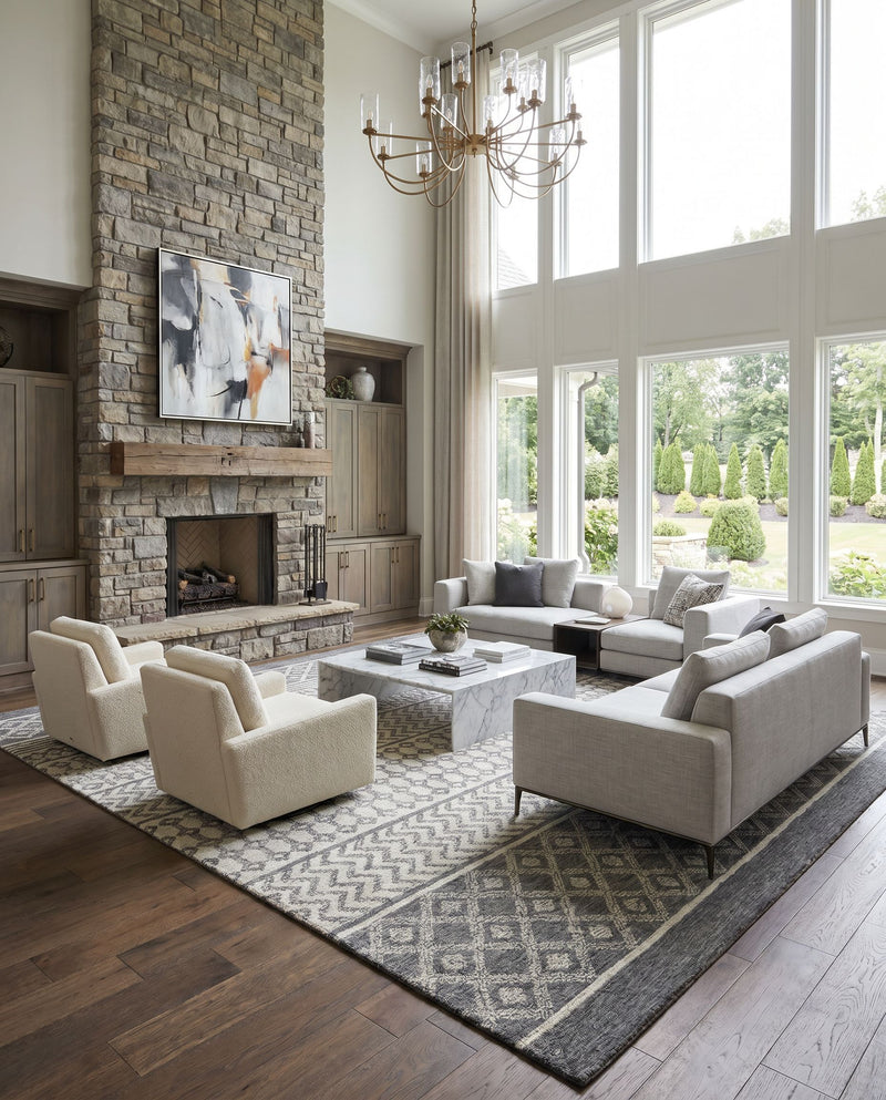 Maroc MAR-2305 Hand Tufted Rug as the centerpiece of a bright luxury living room — a hand tufted global area rug in light beige, oatmeal, charcoal and black tones