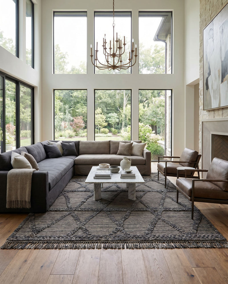 Cadiz CDZ-2302 Hand Knotted Rug as the centerpiece of a bright luxury living room — a hand knotted global area rug in black, gray, charcoal and dark brown tones