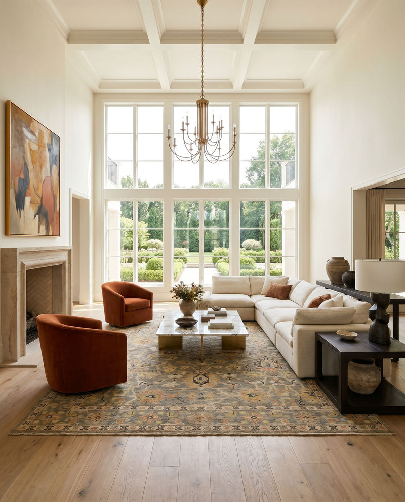 Reign REG-2313 Hand Knotted Rug as the centerpiece of a bright luxury living room — a hand knotted traditional area rug in light brown, black, dark brown and beige tones