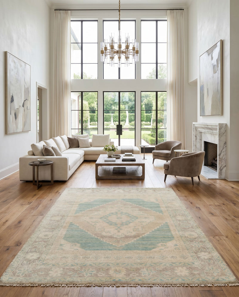 Anadolu AAU-2303 Hand Knotted Rug as the centerpiece of a bright luxury living room — a hand knotted traditional area rug in beige, seafoam, light sage and cream tones