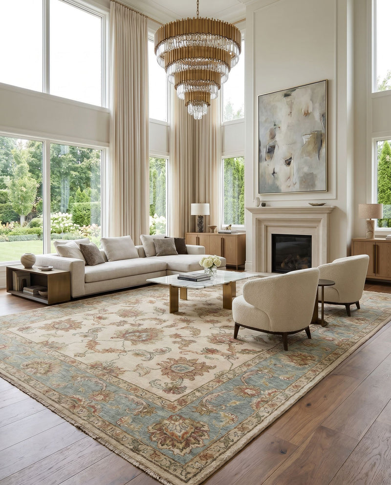 Timeless TIM-7913 Hand Knotted Rug as the centerpiece of a bright luxury living room — a hand knotted traditional area rug in light beige, seafoam, light gray and dusty sage tones
