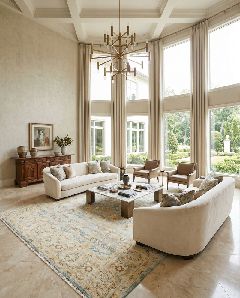 Hamadan HAM-2305 Hand Knotted Rug as the centerpiece of a bright luxury living room — a hand knotted traditional area rug in beige, teal, pale blue and mustard tones