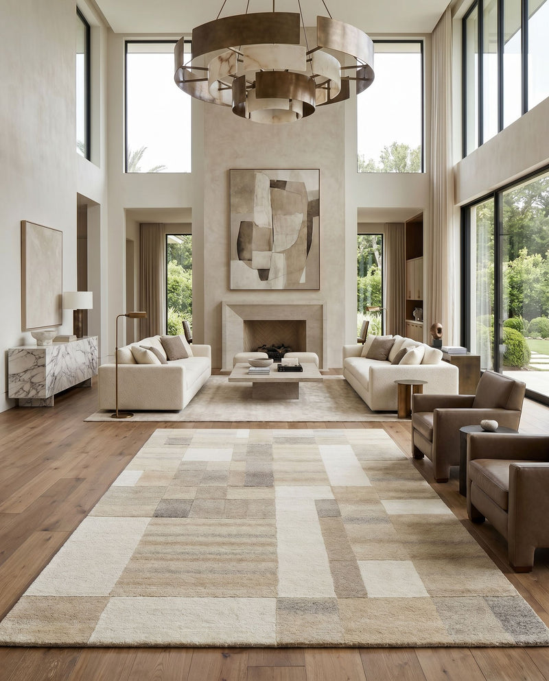 Forum FM-7246 Hand Tufted Rug as the centerpiece of a bright luxury living room — a hand tufted modern area rug in ivory, sandstone, taupe and beige tones