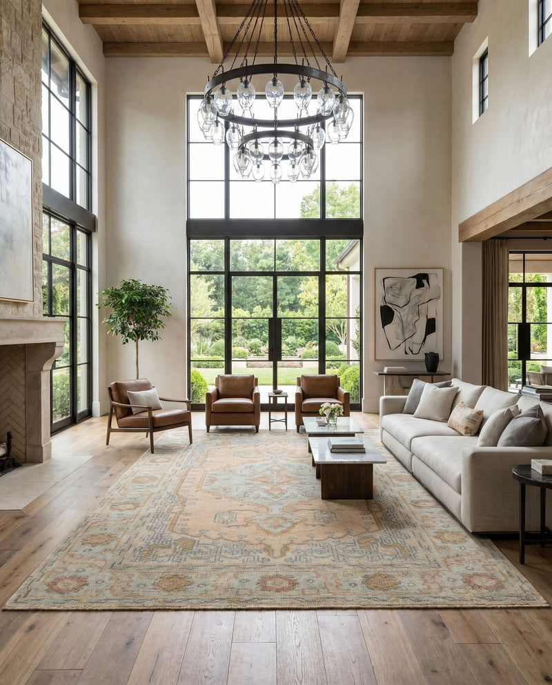 Nirvana NVN-2302 Hand Knotted Rug as the centerpiece of a bright luxury living room — a hand knotted traditional area rug in dusty coral, mustard, beige and medium gray tones