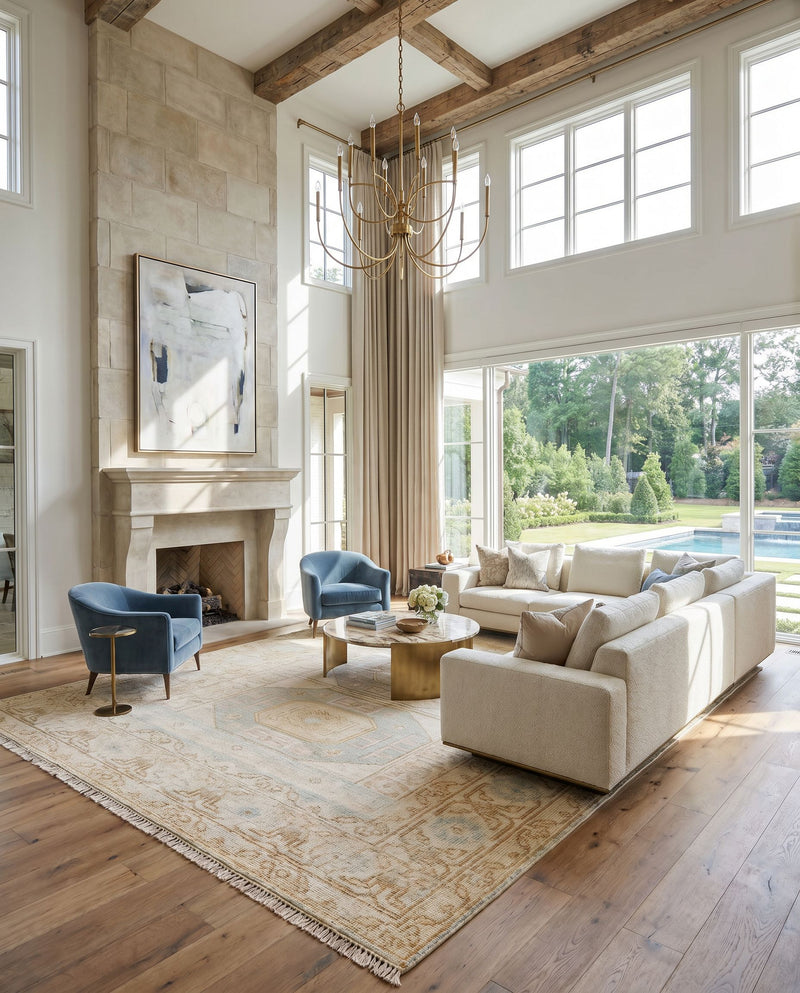 Anadolu AAU-2304 Hand Knotted Rug as the centerpiece of a bright luxury living room — a hand knotted traditional area rug in ice blue, dusty pink, light beige and mustard tones