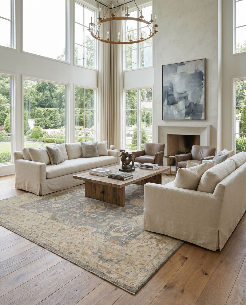 Normandy NOY-8007 Hand Knotted Rug as the centerpiece of a bright luxury living room — a hand knotted traditional area rug in charcoal, medium gray, beige and light blue tones