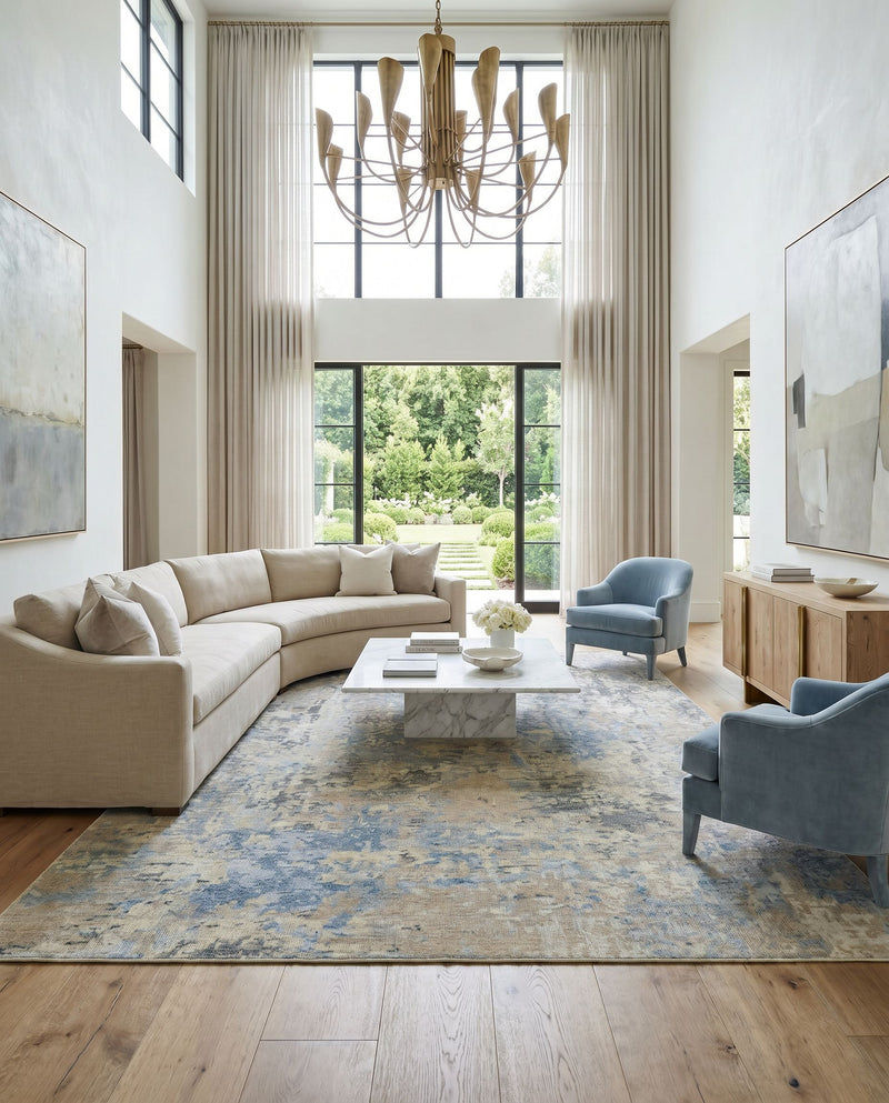 Odyssey ODY-2301 Hand Knotted Rug as the centerpiece of a bright luxury living room — a hand knotted modern area rug in tan, beige, denim and dark blue tones