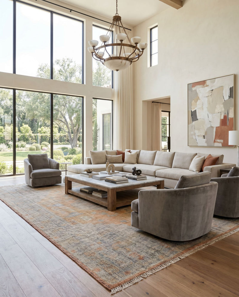 Nirvana NVN-2301 Hand Knotted Rug as the centerpiece of a bright luxury living room — a hand knotted traditional area rug in dusty coral, mustard, beige and medium gray tones