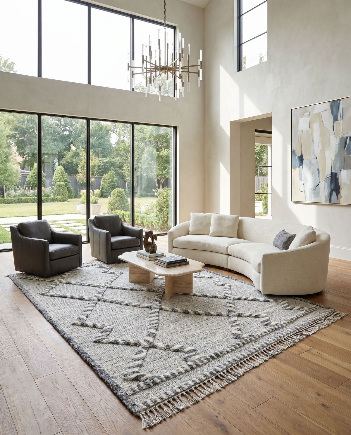 Cadiz CDZ-2301 Hand Knotted Rug as the centerpiece of a bright luxury living room — a hand knotted global area rug in medium gray, dark brown, ivory and medium brown tones
