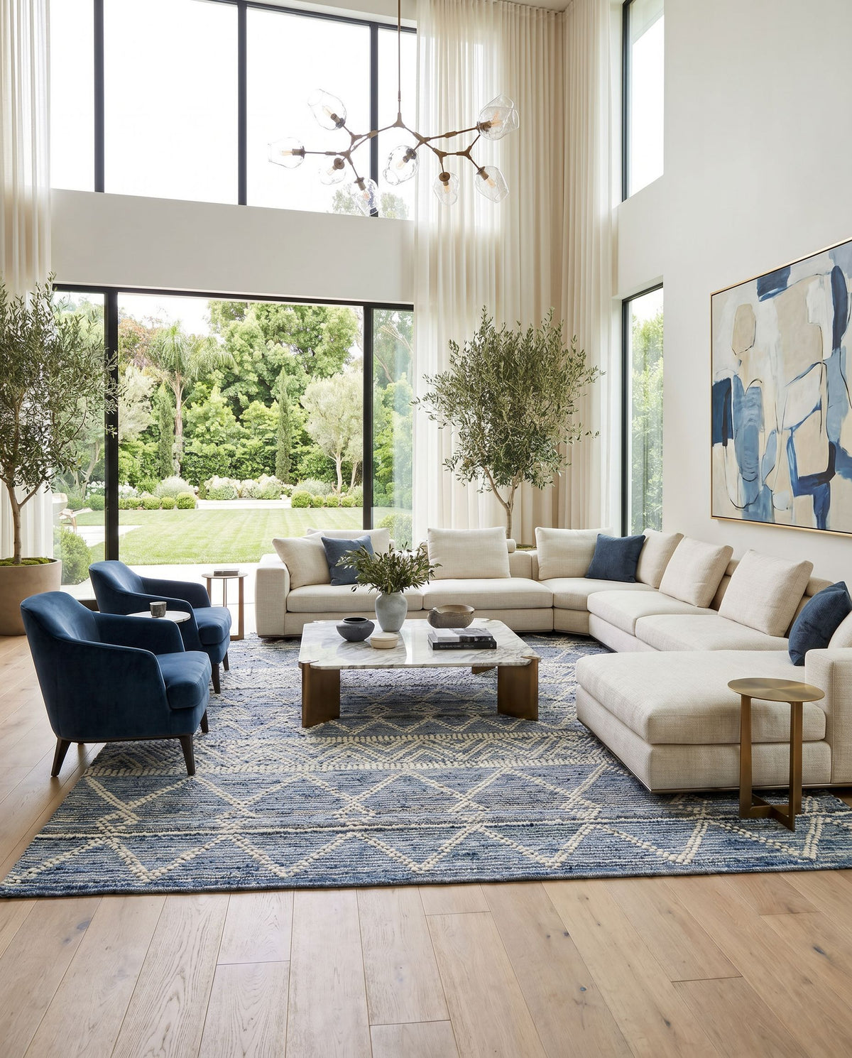Nadine NDD-2301 Hand Woven Rug styled in an elegant designer living room — hand woven global area rug in ivory, navy and dark blue tones