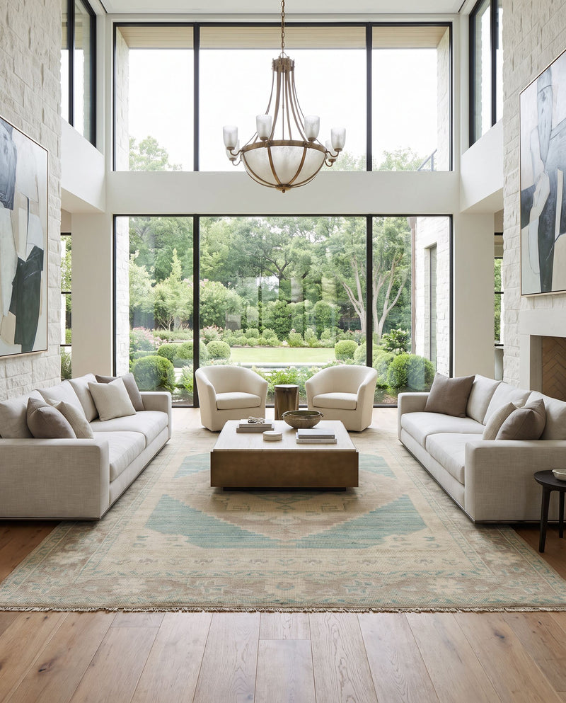 Anadolu AAU-2303 Hand Knotted Rug as the centerpiece of a bright luxury living room — a hand knotted traditional area rug in beige, seafoam, light sage and cream tones
