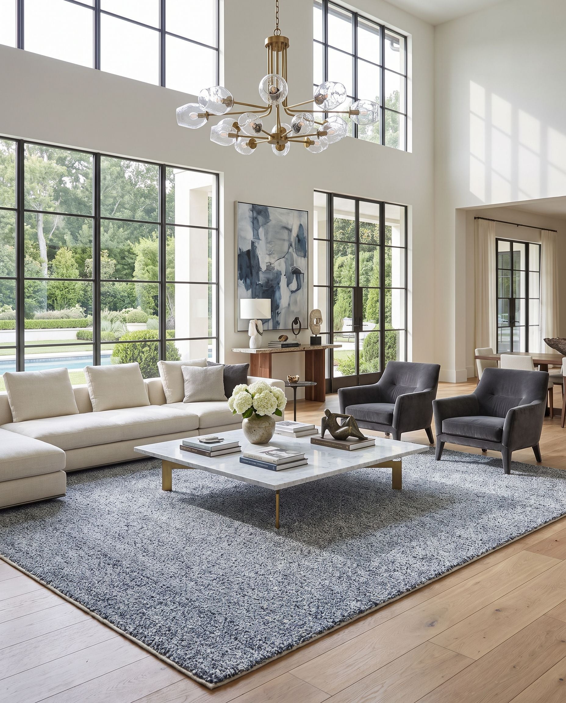 Boculette BCT-2302 Hand Woven Rug as the centerpiece of a bright luxury living room — a hand woven modern area rug in dark blue and off-white tones