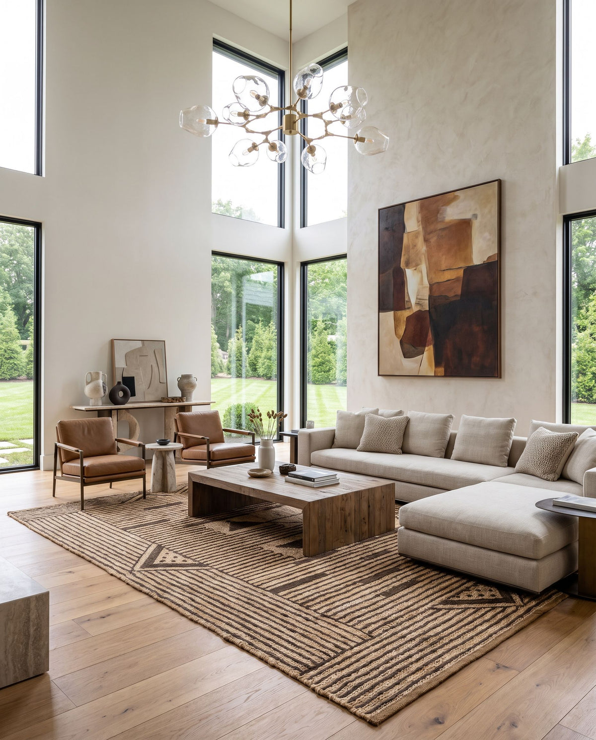 Brookwood BKD-2300 Hand Knotted Rug as the centerpiece of a bright luxury living room — a hand knotted global area rug in wheat and charcoal tones