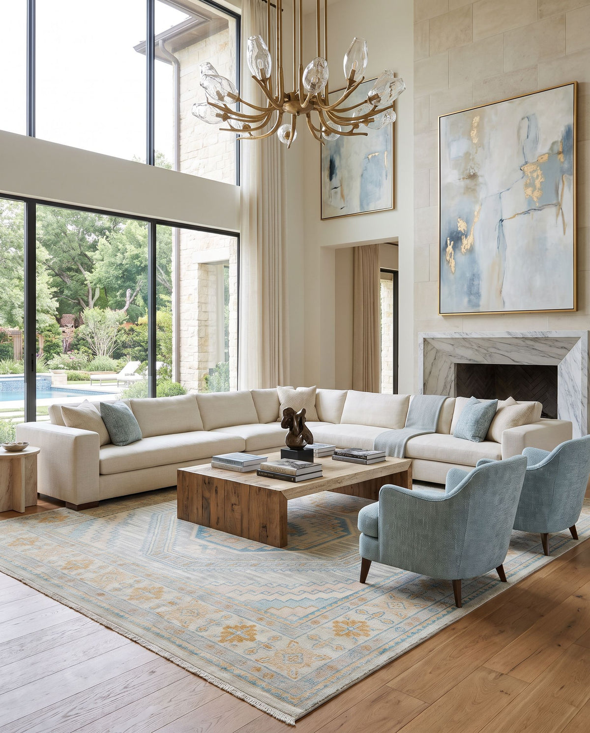 Bunyan BYN-2301 Hand Knotted Rug as the centerpiece of a bright luxury living room — a hand knotted traditional area rug in beige, pale blue, light brown and light slate tones