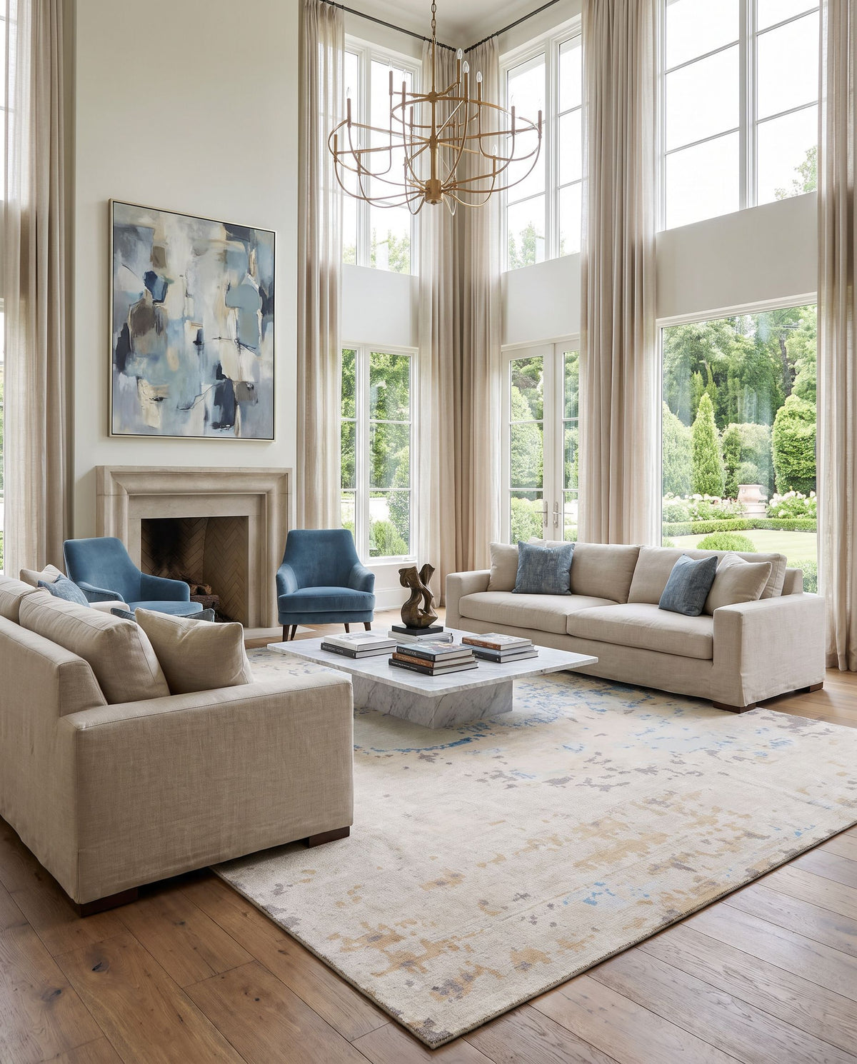 Ephemeral EPH-1000 Hand Knotted Rug styled in an elegant designer living room — hand knotted modern area rug in light blue, light sage, wheat and tan tones