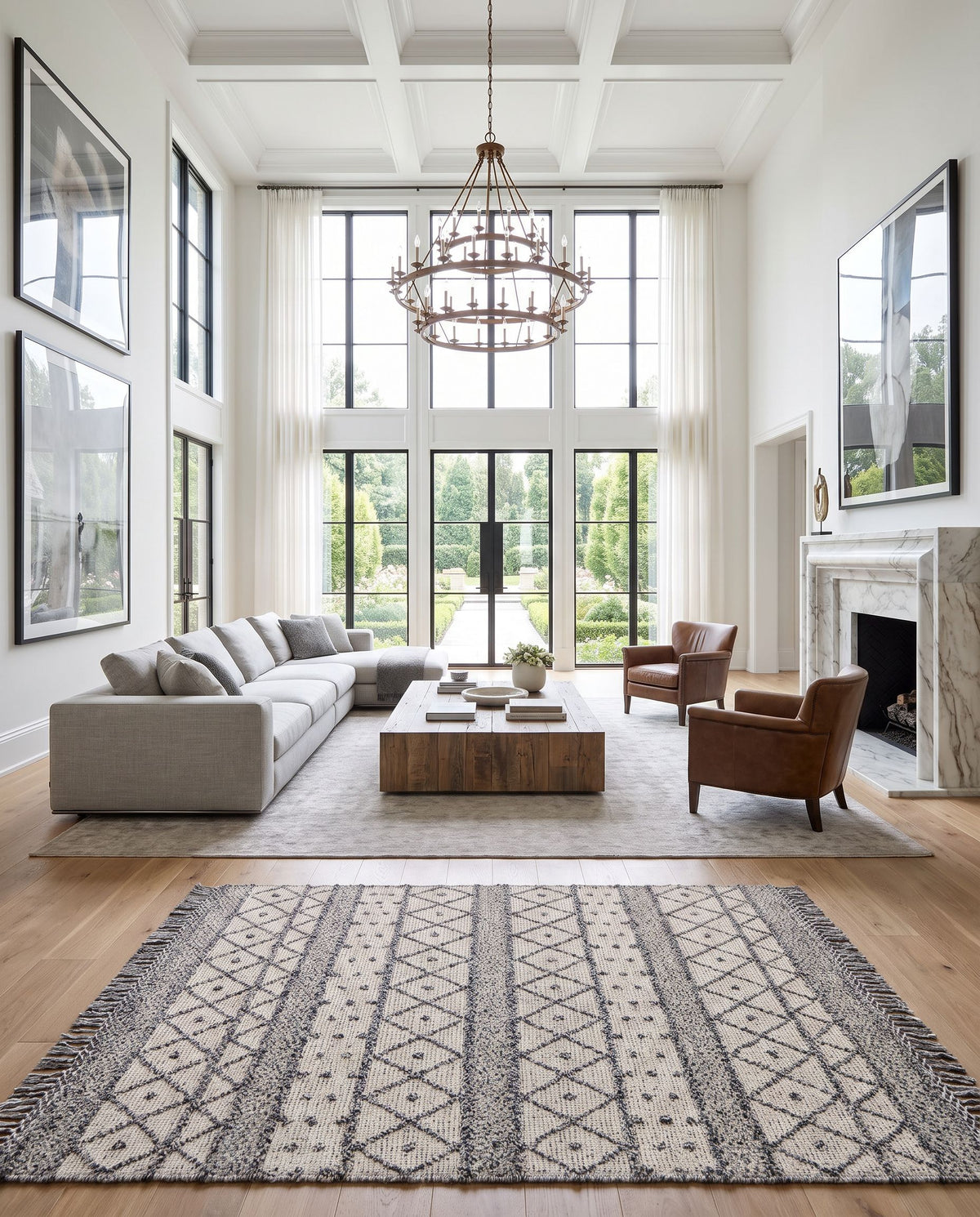Fleur FLE-2305 Hand Woven Rug as the centerpiece of a bright luxury living room — a hand woven global area rug in slate, charcoal and off-white tones