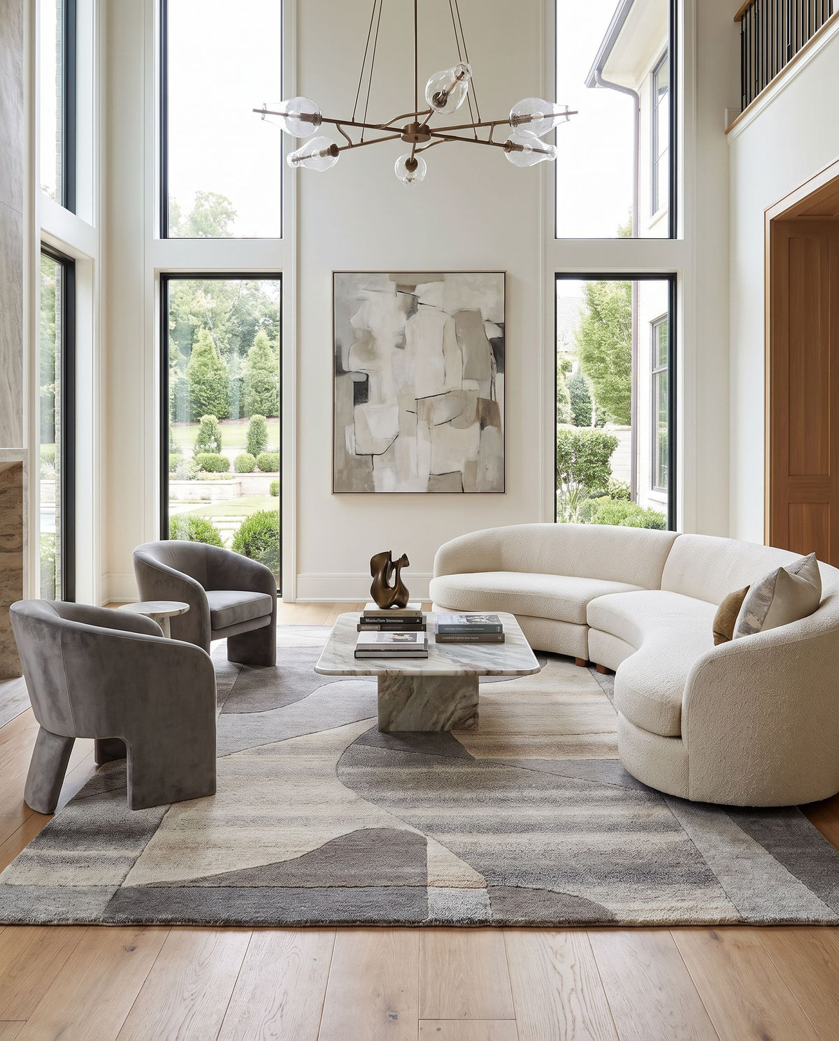 Forum FM-7234 Hand Tufted Rug as the centerpiece of a bright luxury living room — a hand tufted contemporary area rug in taupe, sandstone, charcoal and ash gray tones