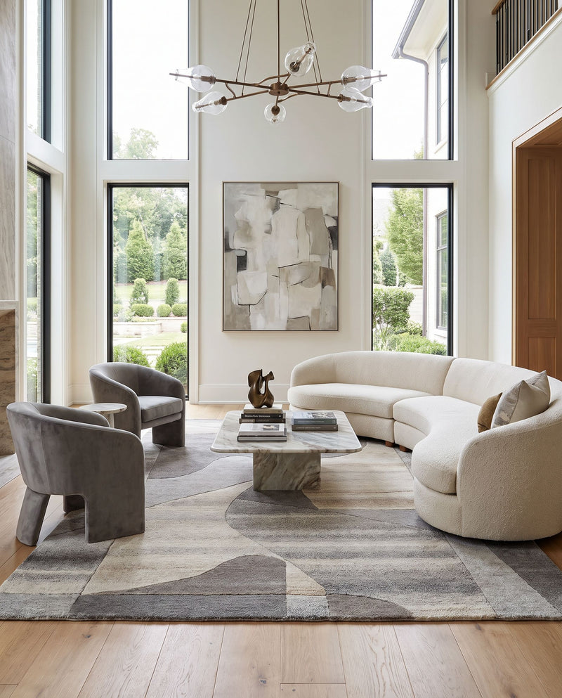 Forum FM-7234 Hand Tufted Rug as the centerpiece of a bright luxury living room — a hand tufted contemporary area rug in taupe, sandstone, charcoal and ash gray tones