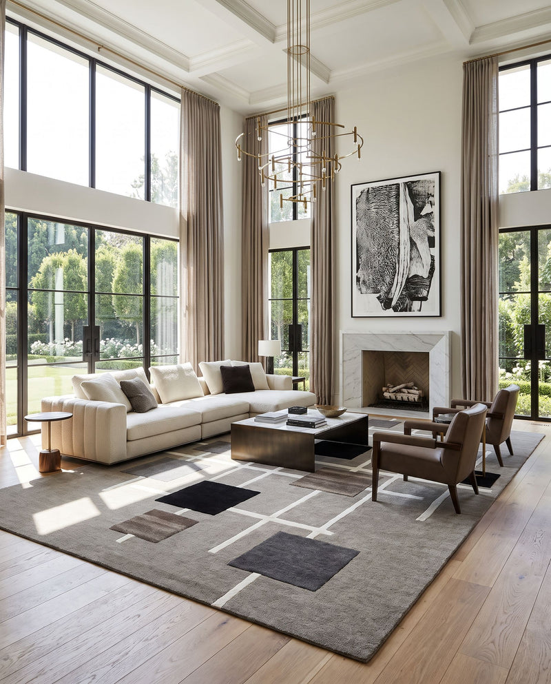 Forum FM-7235 Hand Tufted Rug as the centerpiece of a bright luxury living room — a hand tufted contemporary area rug in taupe, charcoal, slate gray and ivory tones