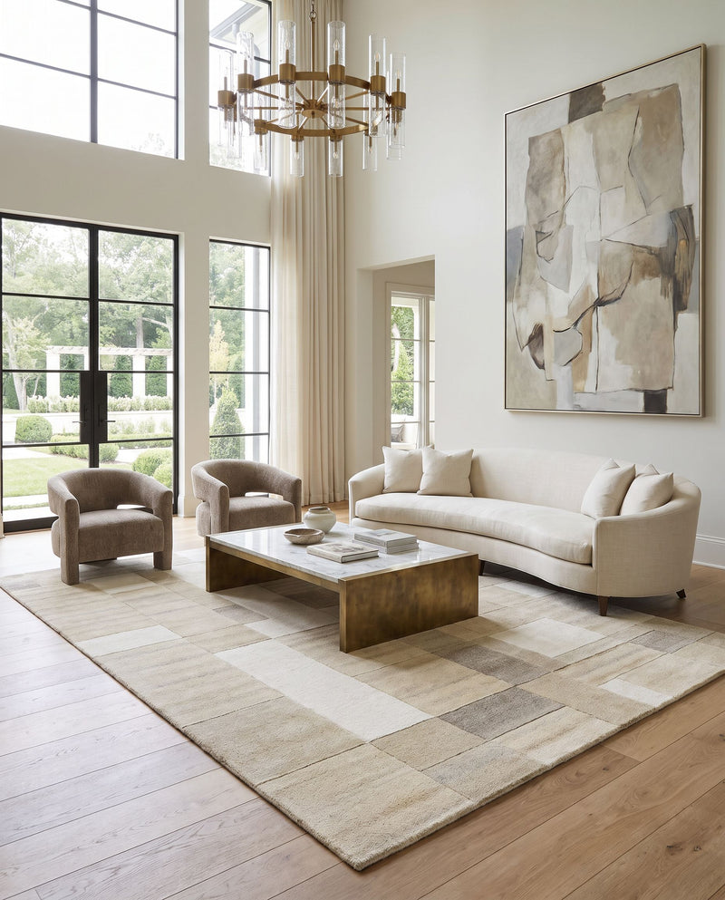 Forum FM-7246 Hand Tufted Rug as the centerpiece of a bright luxury living room — a hand tufted modern area rug in ivory, sandstone, taupe and beige tones