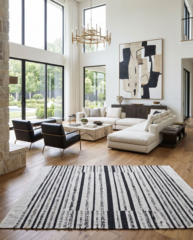 Goteborg GTG-2300 Hand Woven Rug as the centerpiece of a bright luxury living room — a hand woven modern area rug in ivory and black tones