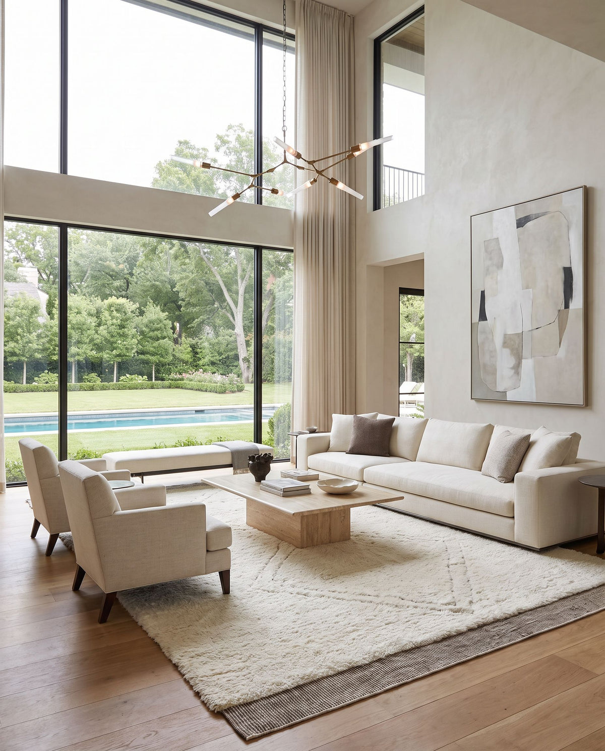 Meknes MEK-1006 Hand Knotted Rug as the centerpiece of a bright luxury living room — a hand knotted global area rug in oatmeal, gray, charcoal and black tones