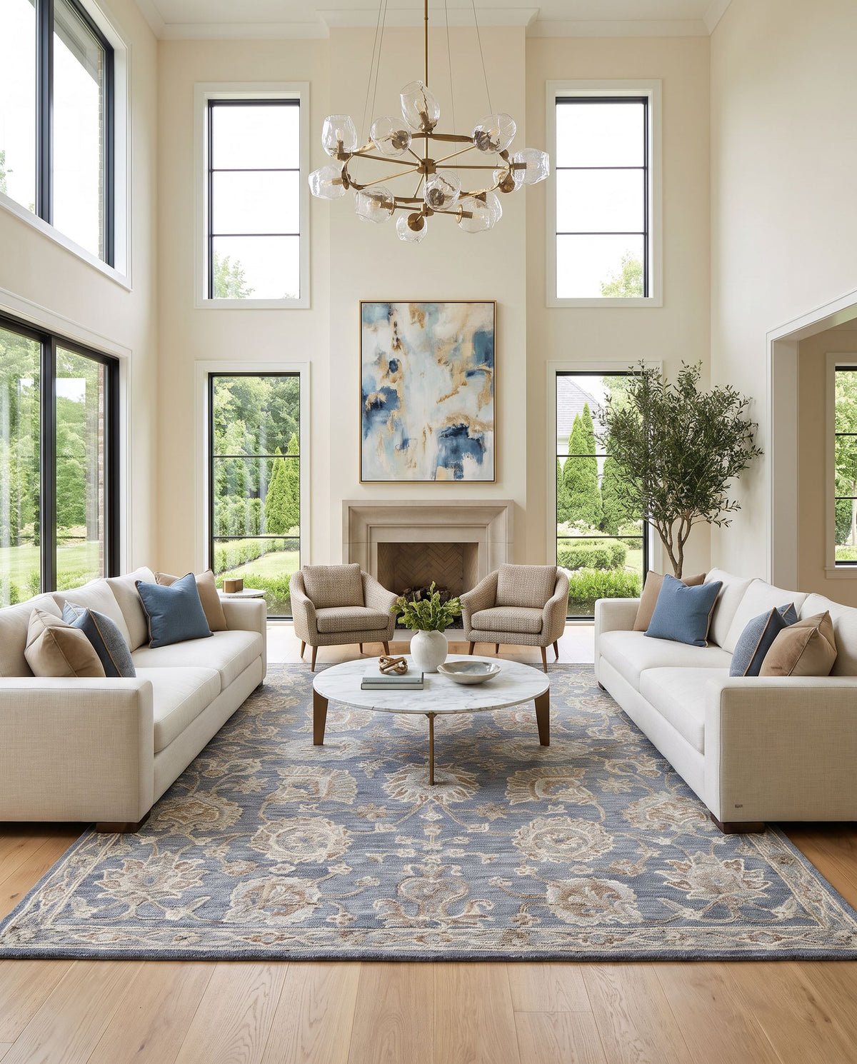 Visby Hand Tufted Rug as the centerpiece of a bright luxury living room — a hand tufted traditional area rug in slate gray, ivory, sandstone and taupe tones