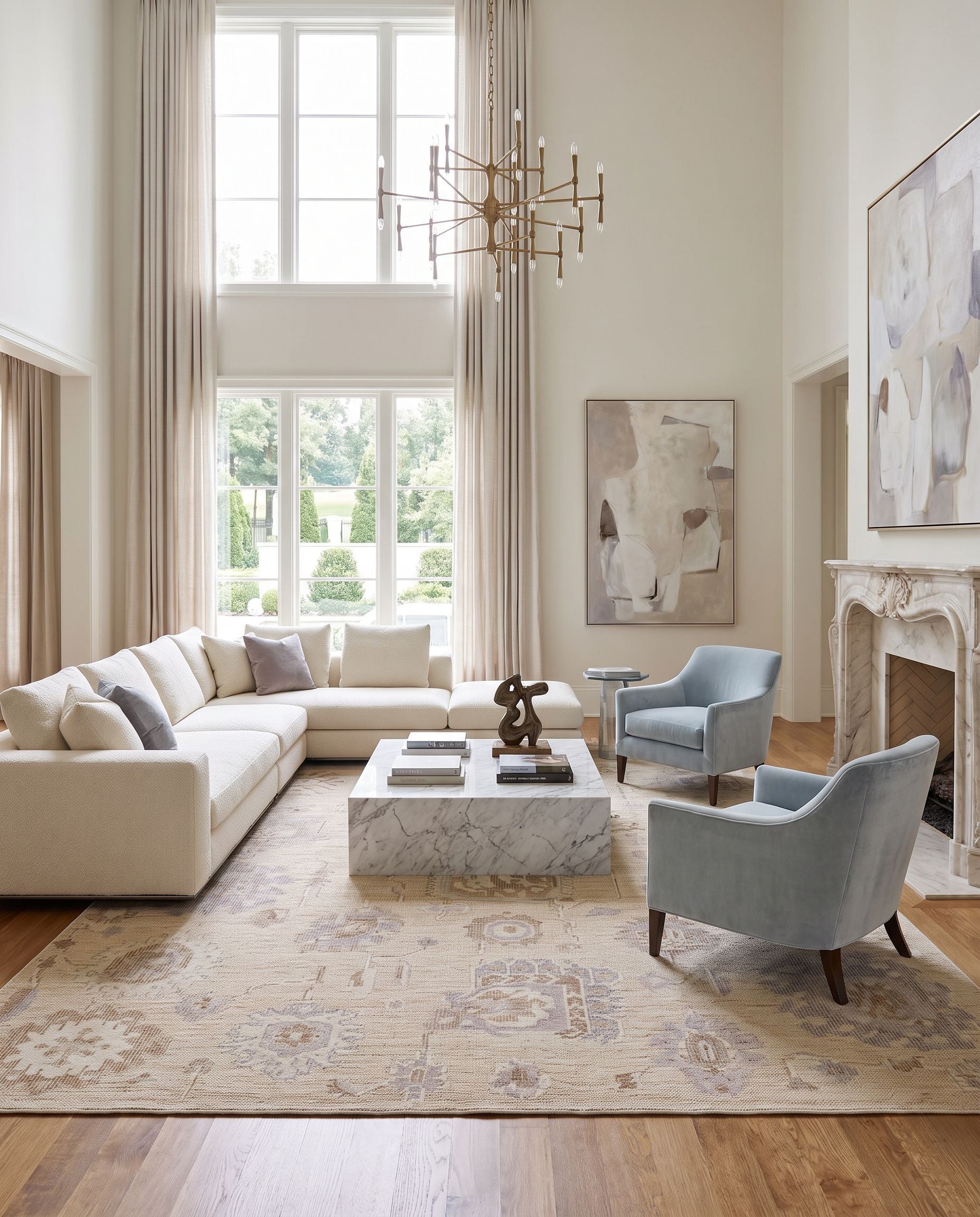 Revere RVE-2301 Hand Knotted Rug as the centerpiece of a bright luxury living room — a hand knotted traditional area rug in light gray, brown, light beige and cream tones