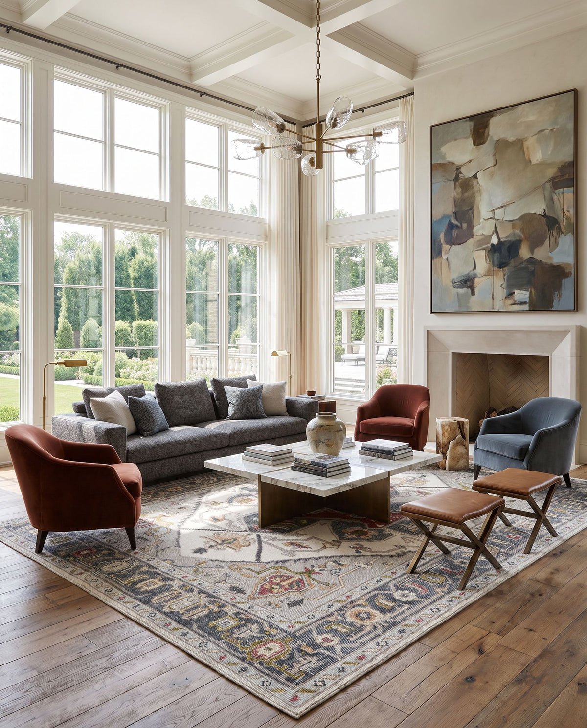 Revere RVE-2307 Hand Knotted Rug as the centerpiece of a bright luxury living room — a hand knotted traditional area rug in medium gray, light gray, pale blue and brown tones