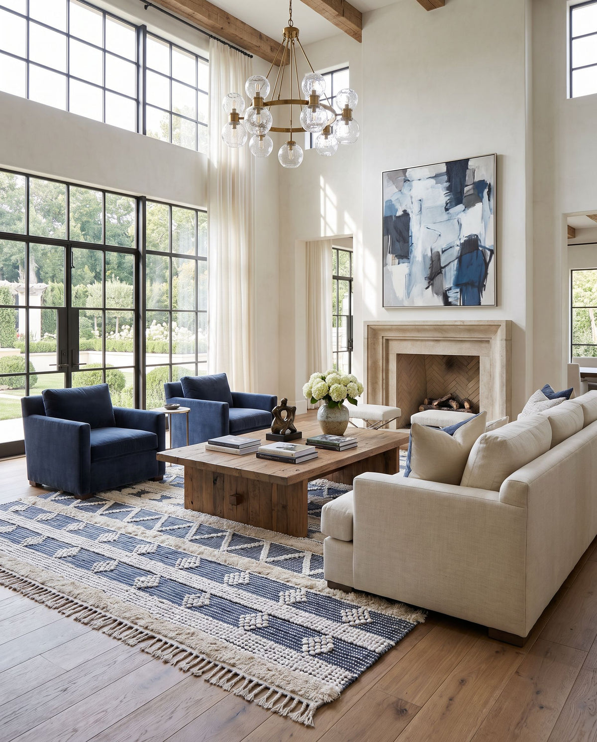 Serena SER-2300 Hand Woven Rug as the centerpiece of a bright luxury living room — a hand woven global area rug in ivory, dark blue, blue and light beige tones