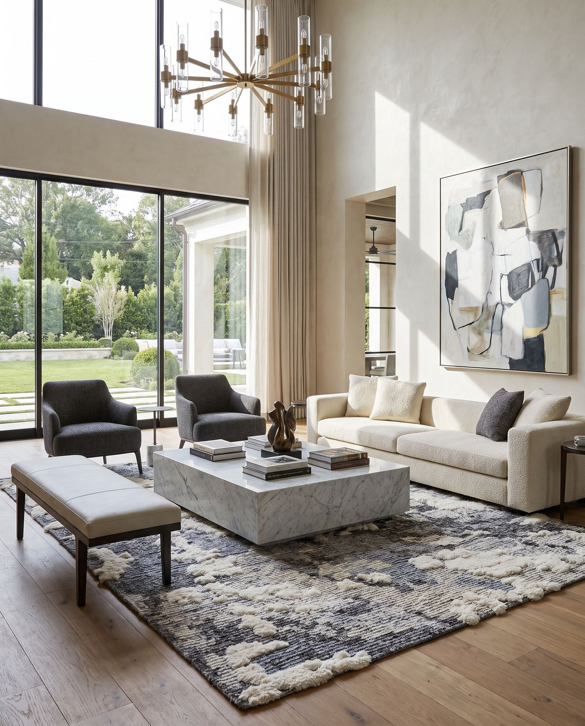 Socrates SOC-2301 Hand Knotted Rug as the centerpiece of a bright luxury living room — a hand knotted modern area rug in cream, black, charcoal and light gray tones