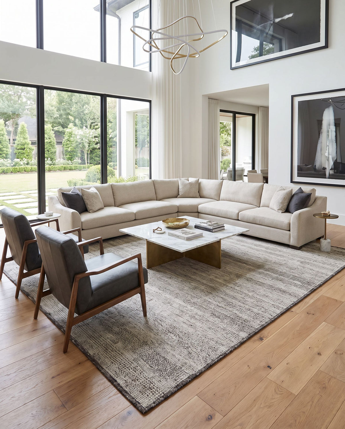Tunus TUN-2305 Hand Knotted Rug as the centerpiece of a bright luxury living room — a hand knotted global area rug in gray, off-white, black and light sage tones